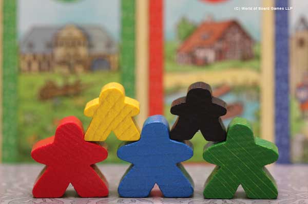 Cardcassonne meeples posing in front of their houses